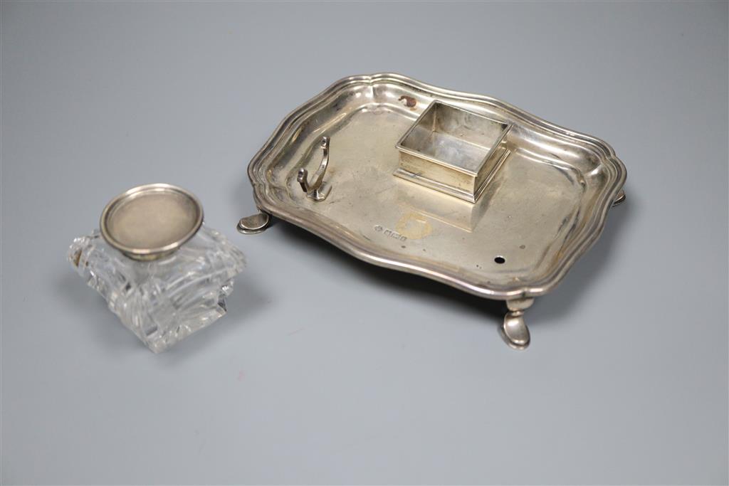 An Edwardian silver inkstand with mounted glass well and pen rest (one rest missing), William Hutton & Sons,